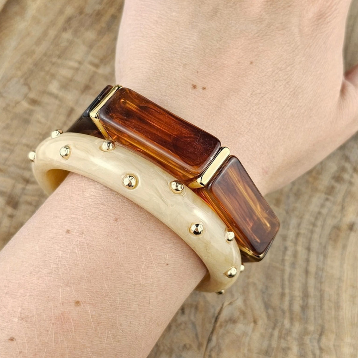 Brede cognackleurige dames armband met amber patroon en goudkleurige tussenstukken