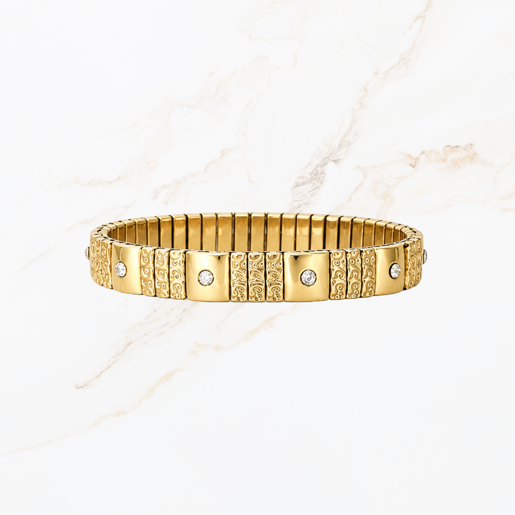 Elastische goudkleurige bangle met steentjes en structuur