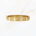 Elastische goudkleurige bangle met steentjes en structuur