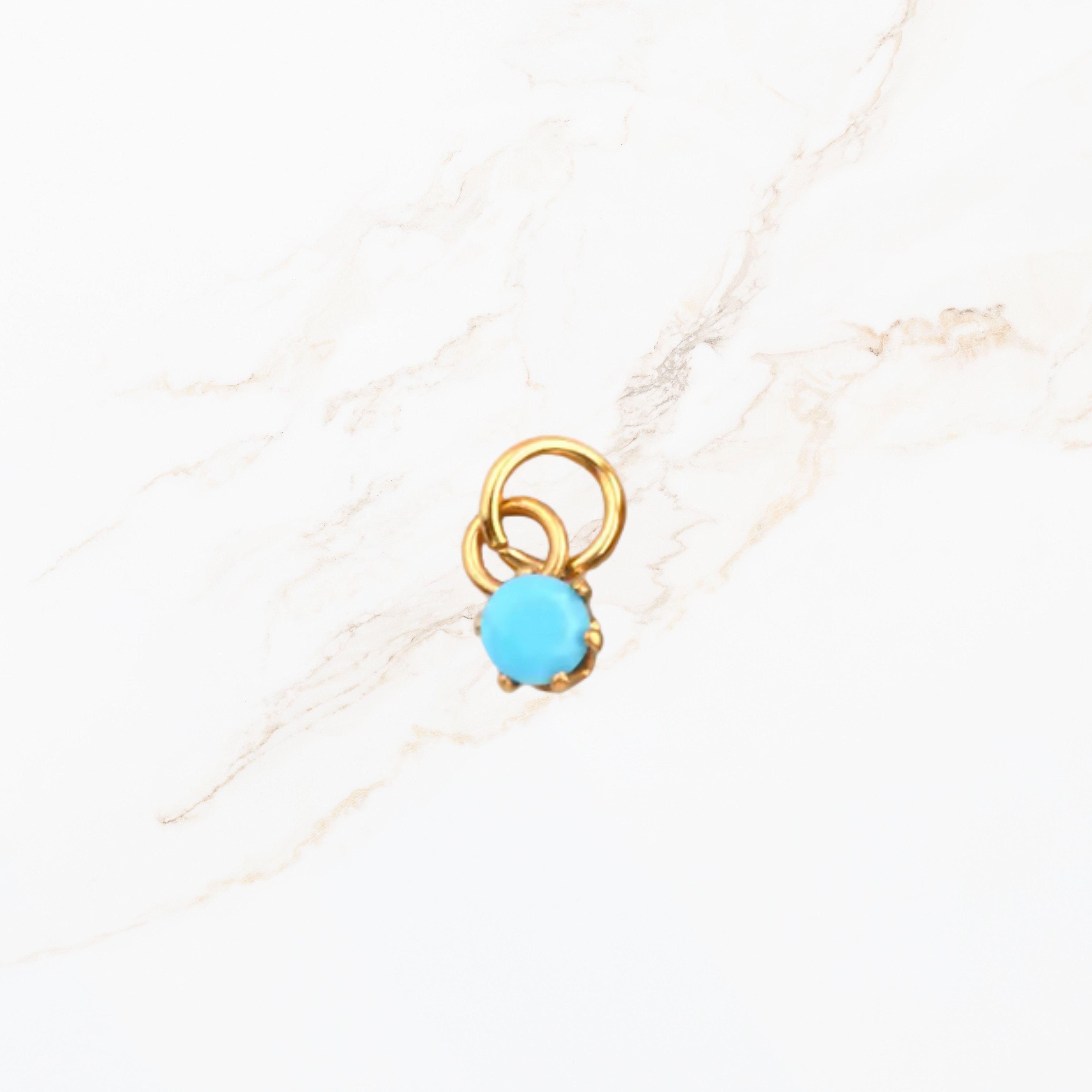 Geboortesteen ronde bedel december met turquoise blauwe edelsteen