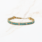 Goudkleurige armband met blauwe steentjes 