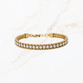 Goudkleurige armband met witte steentjes