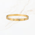 Goudkleurige klaver bangle met steentjes