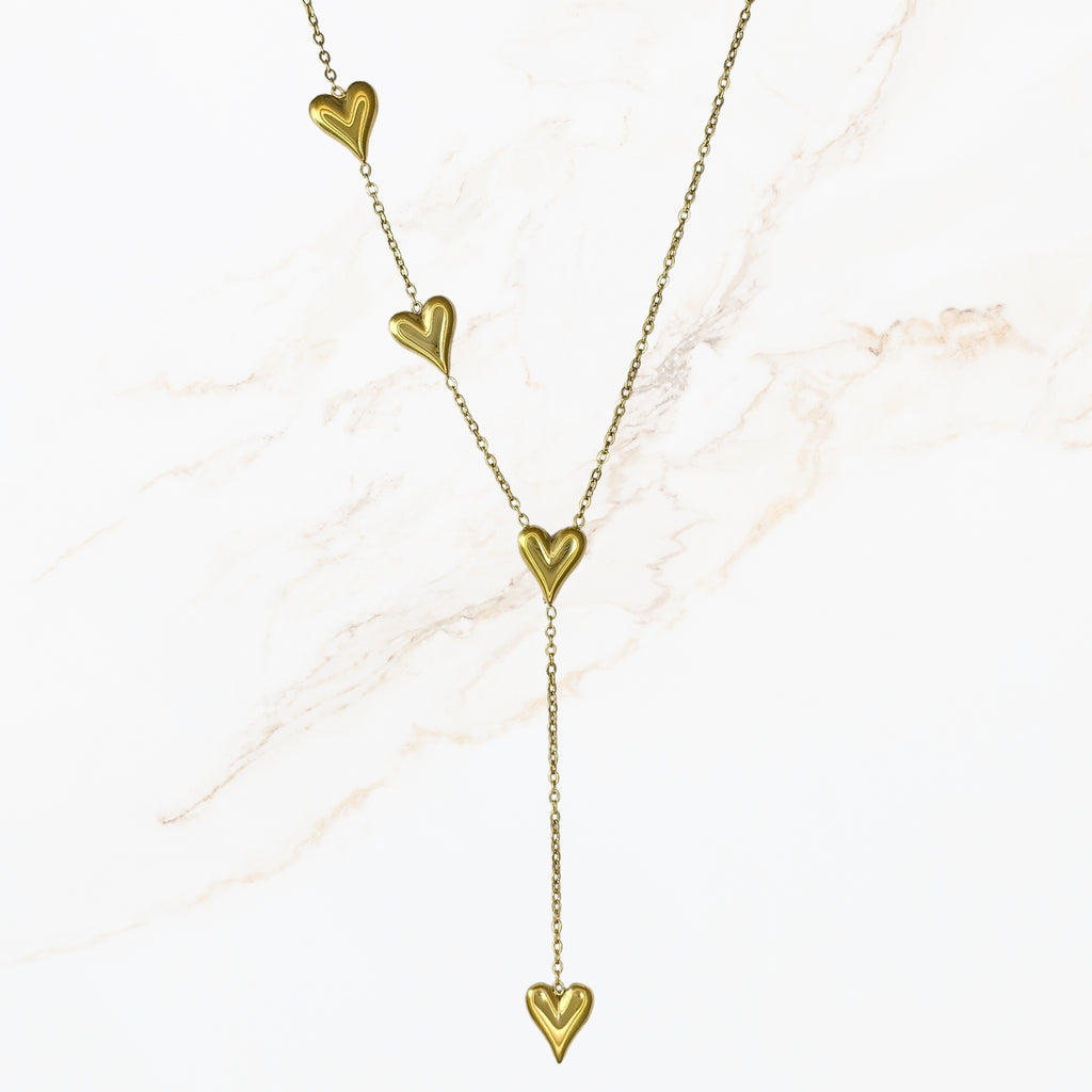 Goudkleurige stainless steel Y ketting met fijne schakels en meerdere hartdetails