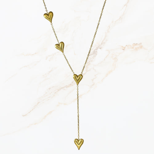 Goudkleurige stainless steel Y ketting met fijne schakels en meerdere hartdetails