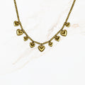 Goudkleurige stainless steel kralenketting met meerdere kleine hartbedels