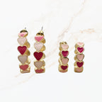 Seyso grote hoops met roze en fuchsia hartjes in goudkleurige setting