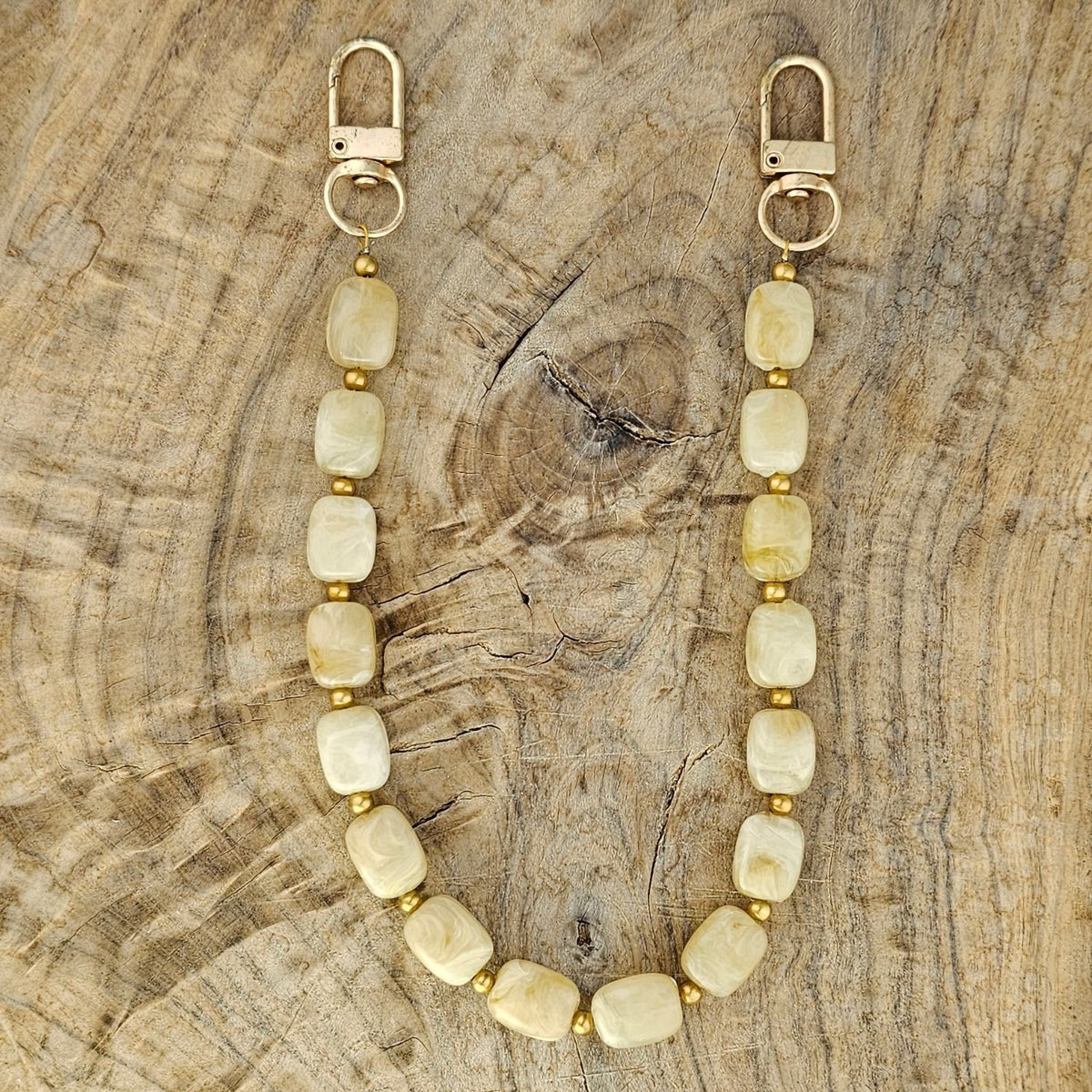 Beige telefoonkoord met rvs gouden balletjes