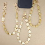 Beige telefoonkoord met rvs gouden balletjes