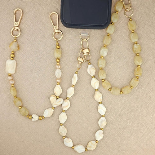 Beige telefoonkoord met rvs gouden balletjes
