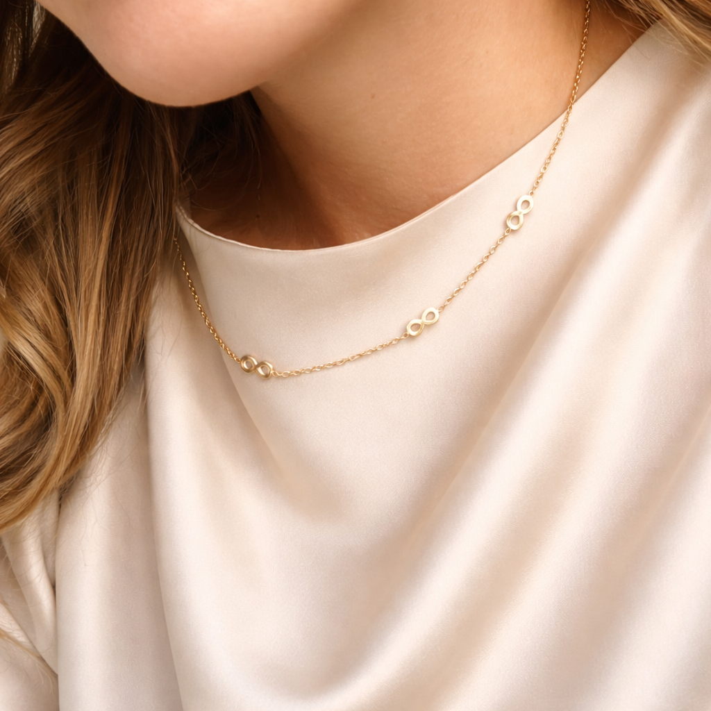 Goudkleurige stainless steel schakelketting van 45 cm plus 5 cm met meerdere infinity symbolen